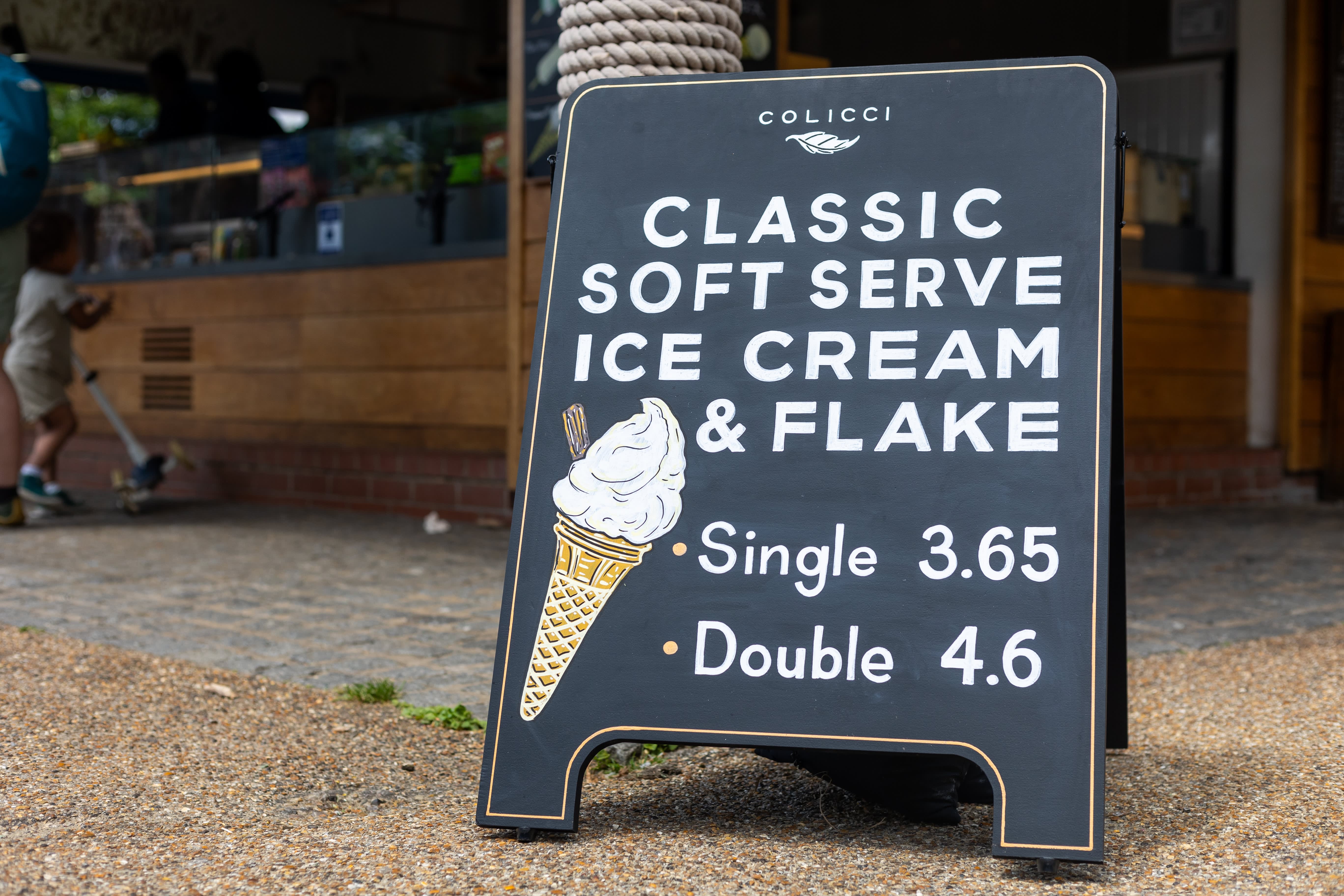 A Colicci A-board with Classic Soft Serve Ice Cream and Flake lettering and an ice cream illustration.