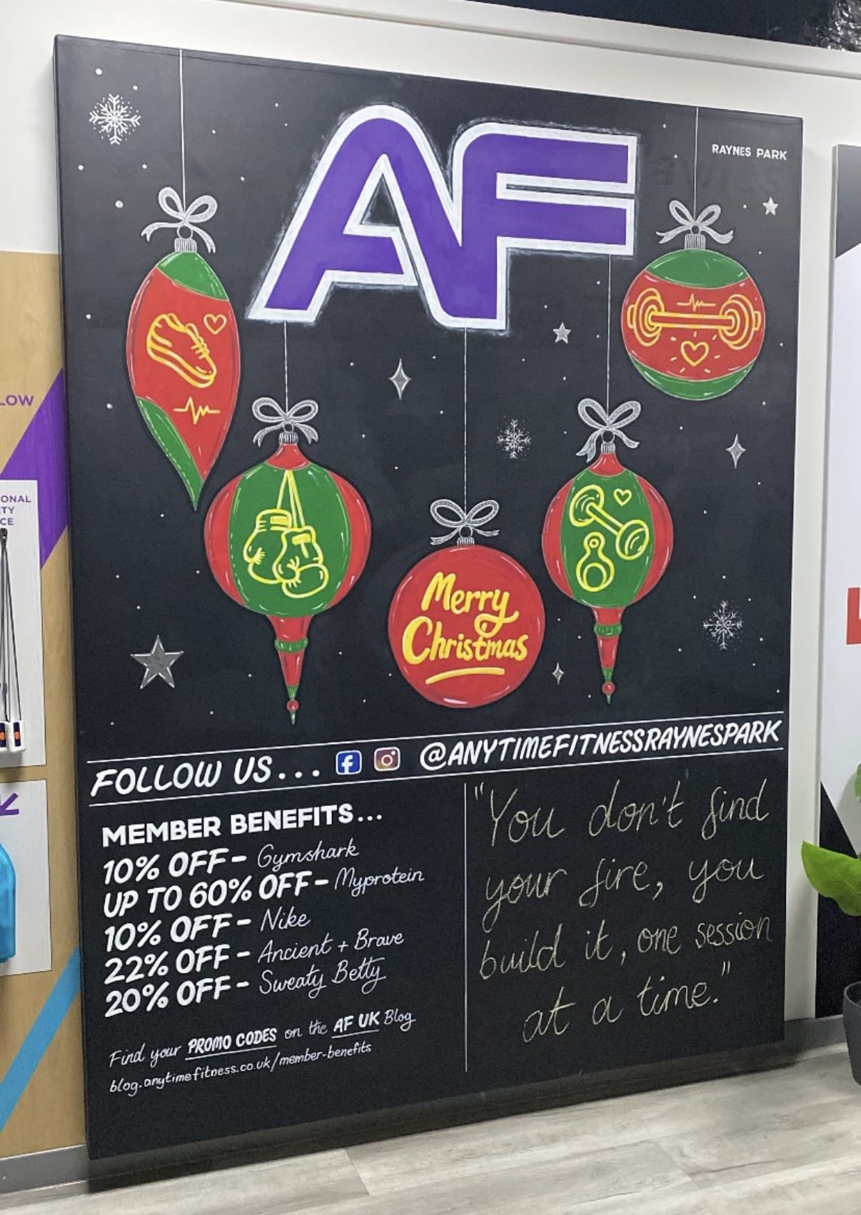 Anytime Fitness Christmas blackboard with colourful fitness-themed baubles