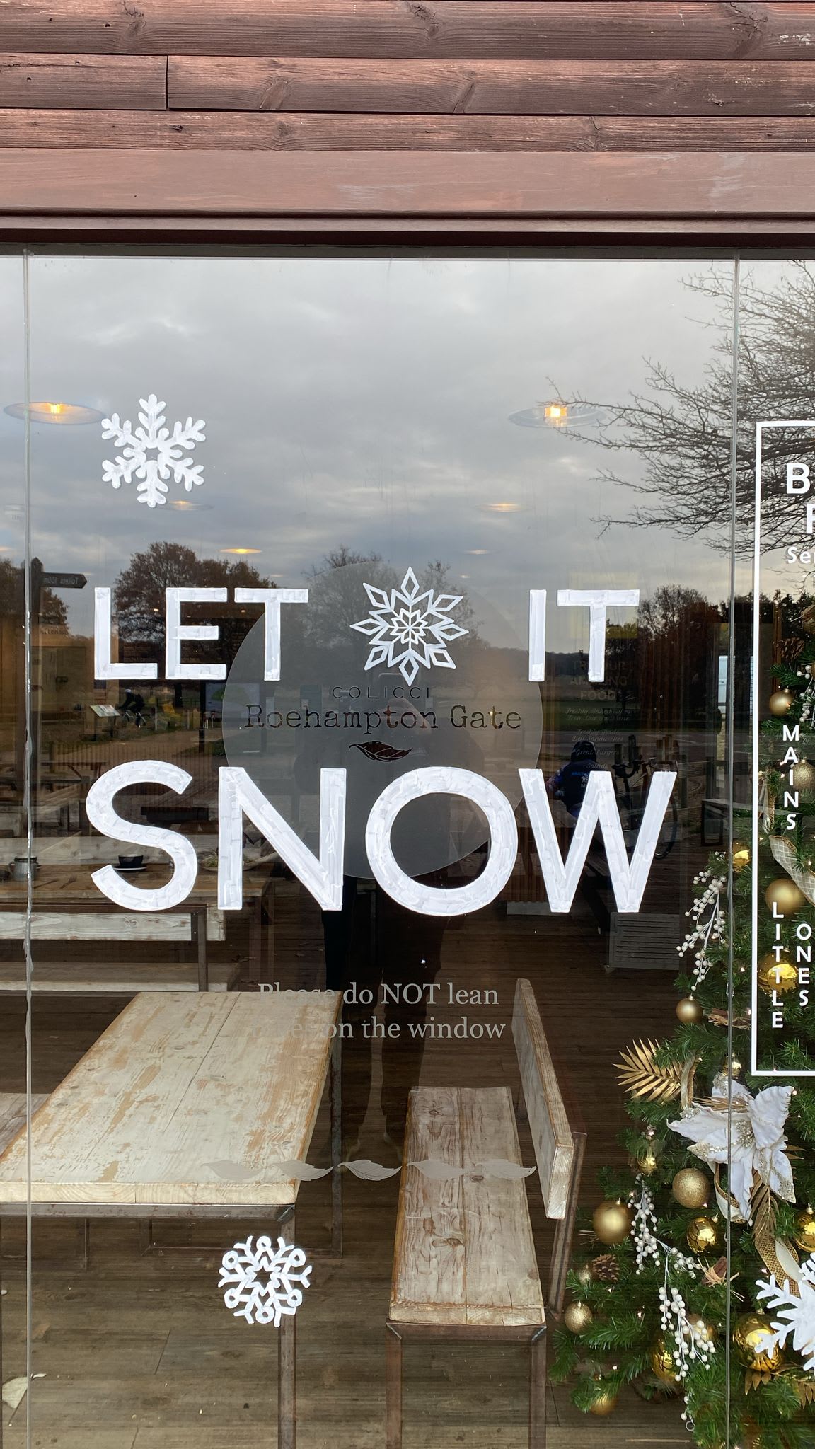 Let It Snow lettering and snowflakes on a Colicci café window