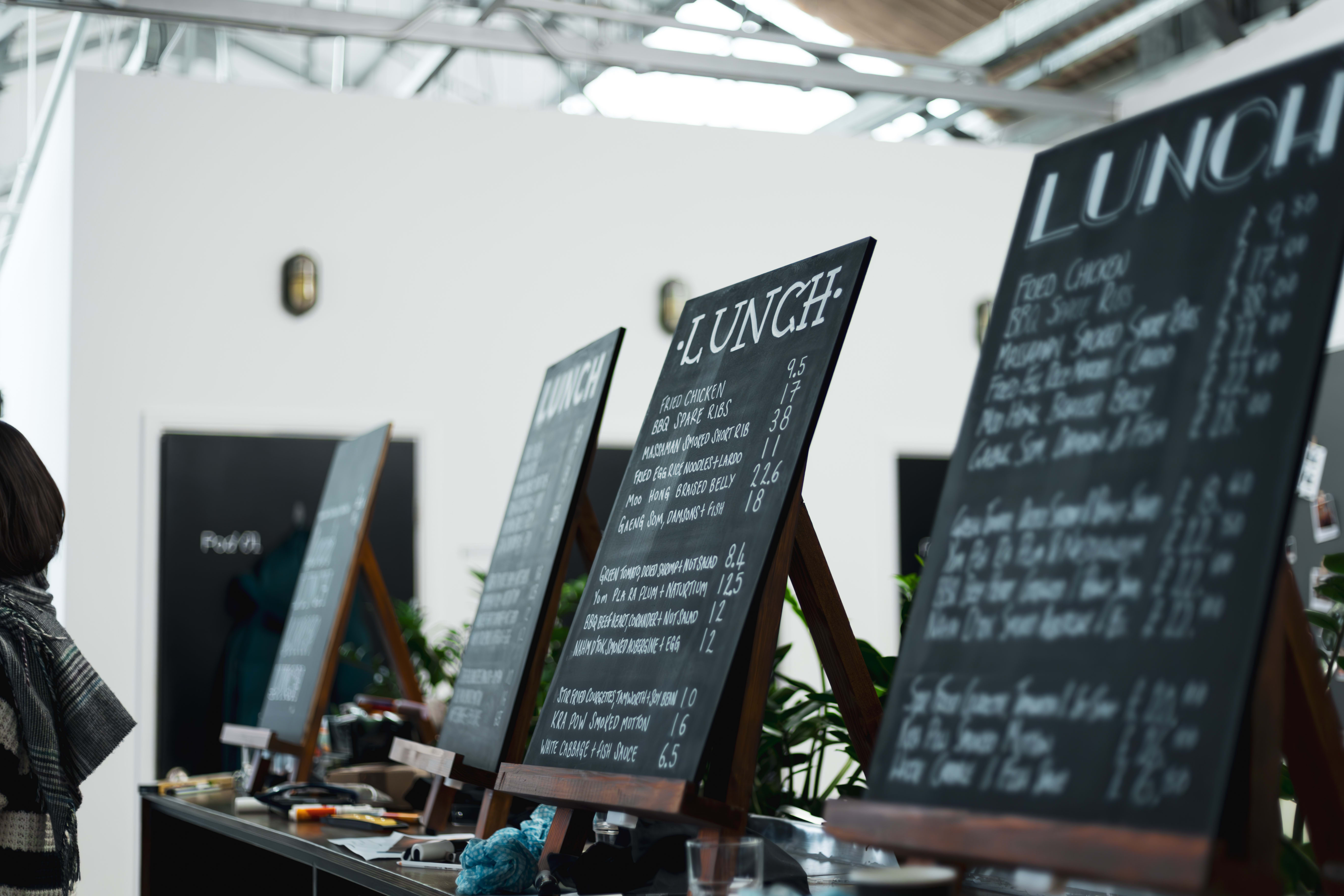 Lunch menu blackboards arranged on easels during a workshop.