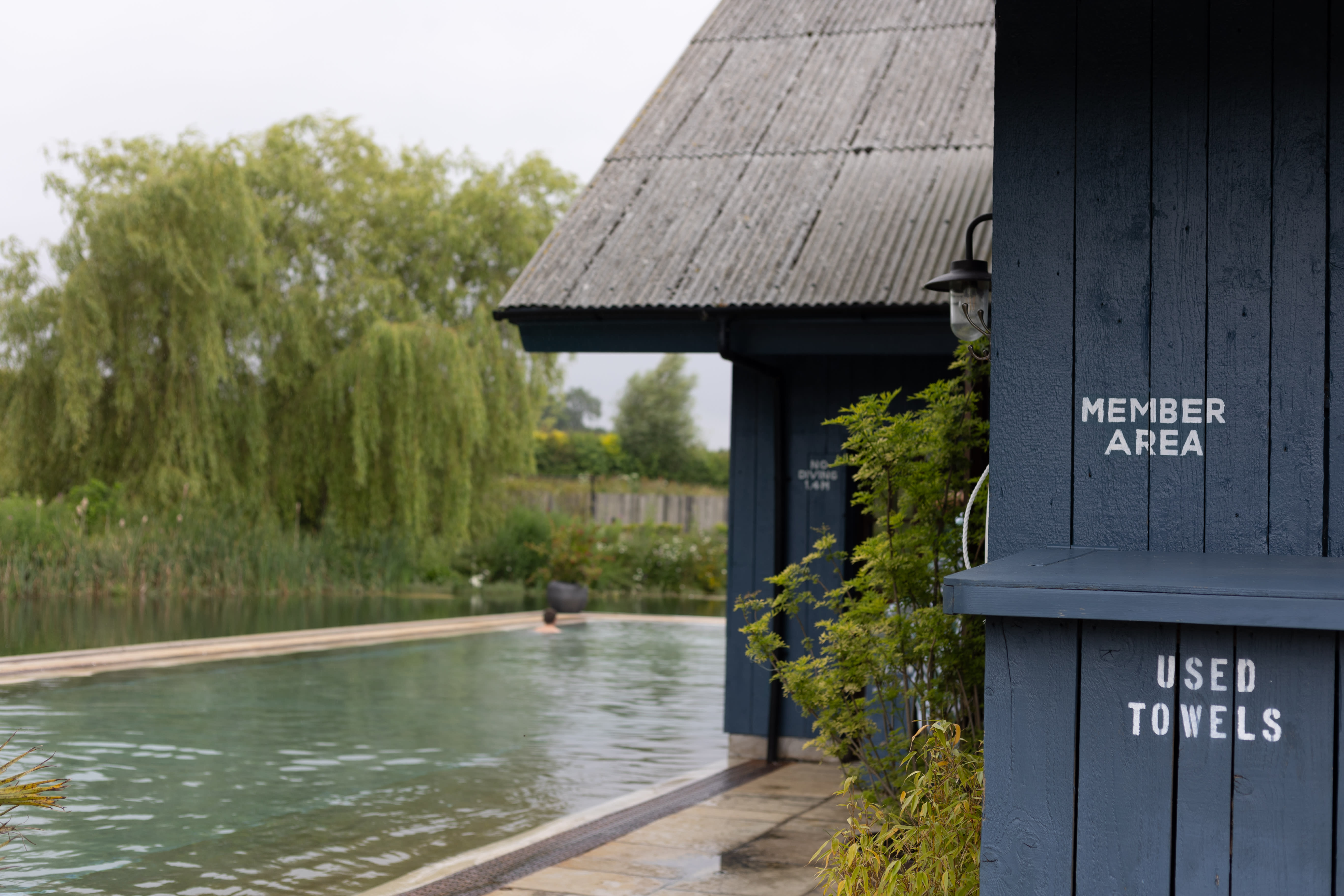 Member Area and Used Towels lettering beside the pool at Soho Farmhouse.