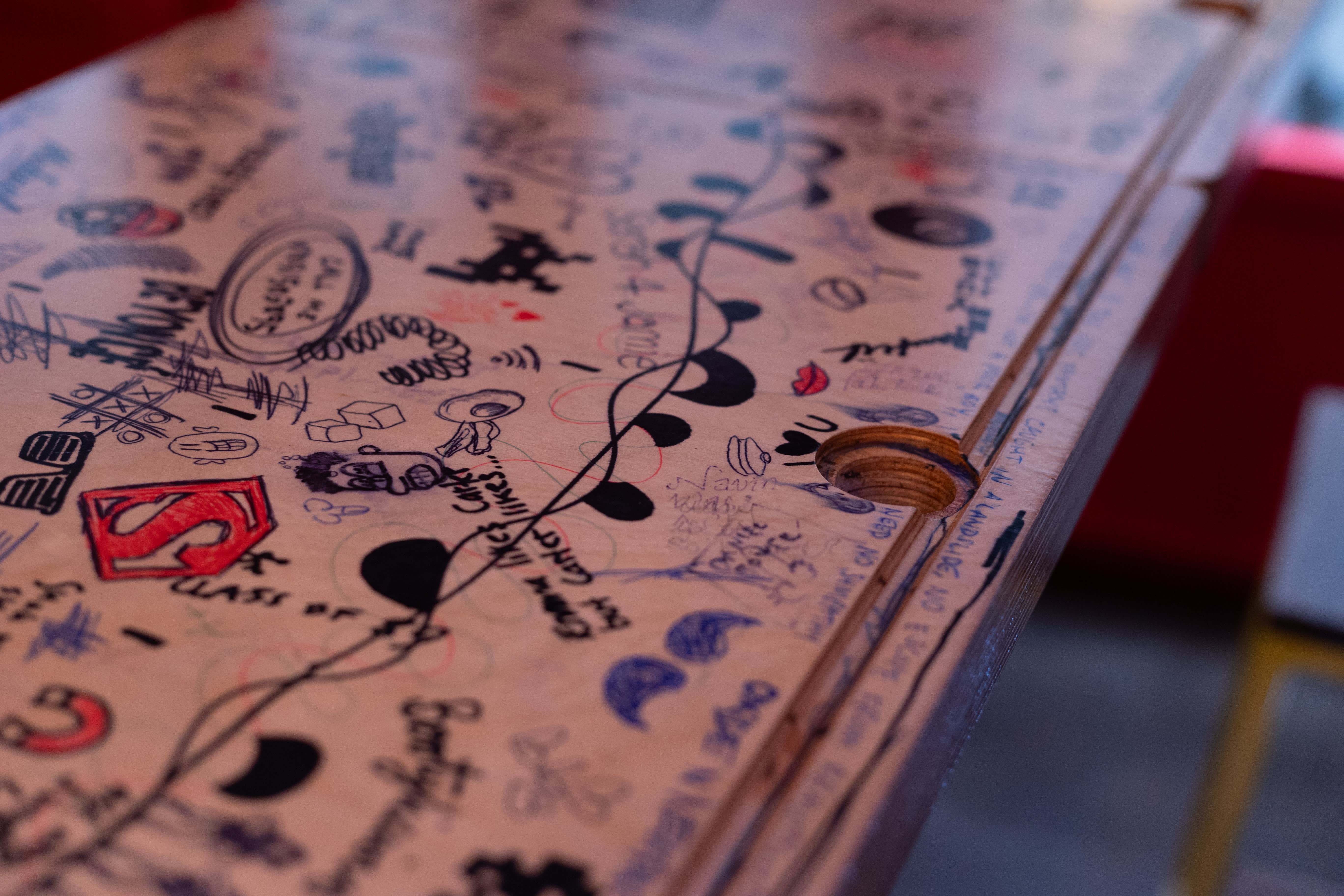A tabletop covered with hand-drawn drinks, music and decorative illustrations at Simmons.